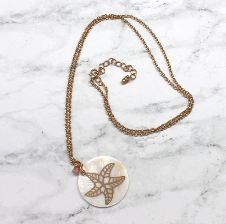 A photo of the Starfish On A Shell Necklace product