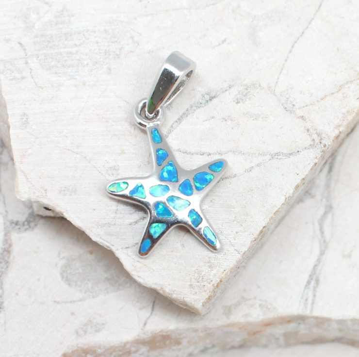 A photo of the The Small Opal Starfish Pendant product