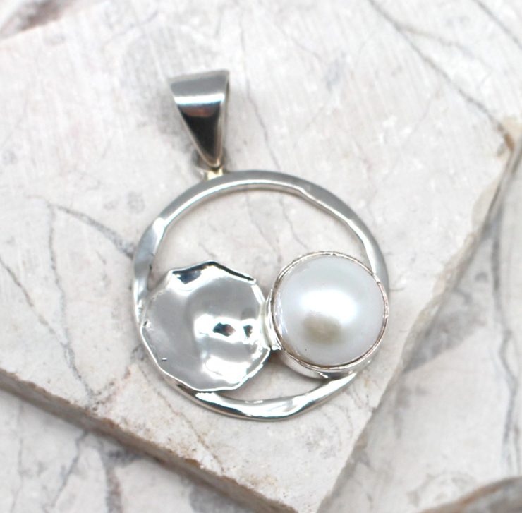 A photo of the The Circle Mother Pearl Pendant product