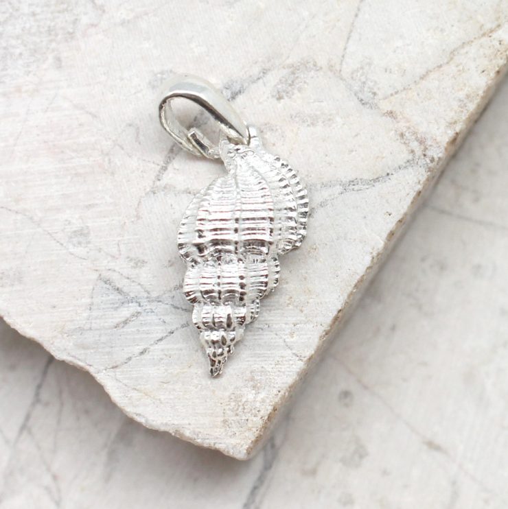 A photo of the The Striped Shell Pendant product