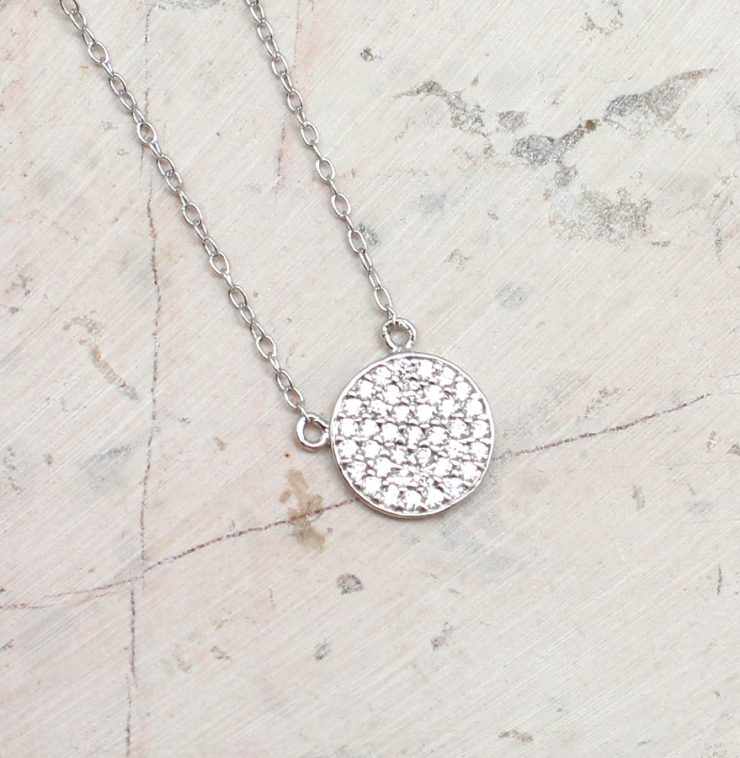 A photo of the Cubic Zirconia Pave Coin Necklace product