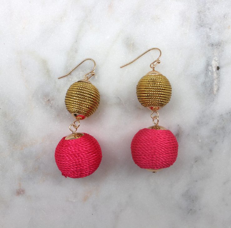 A photo of the Two Tone Thread Ball Earrings product