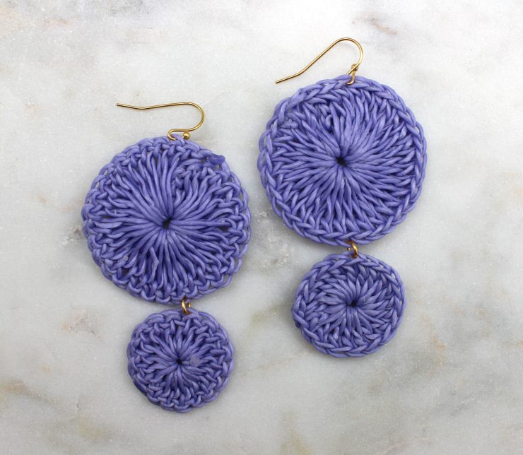 A photo of the Shimmer Thread Wrap Ball Earrings product