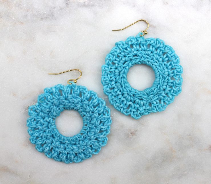 A photo of the Shimmer Thread Wrap Ball Earrings product