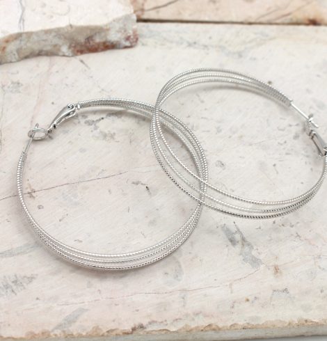 A photo of the Triple The Trouble Hoop Earrings product