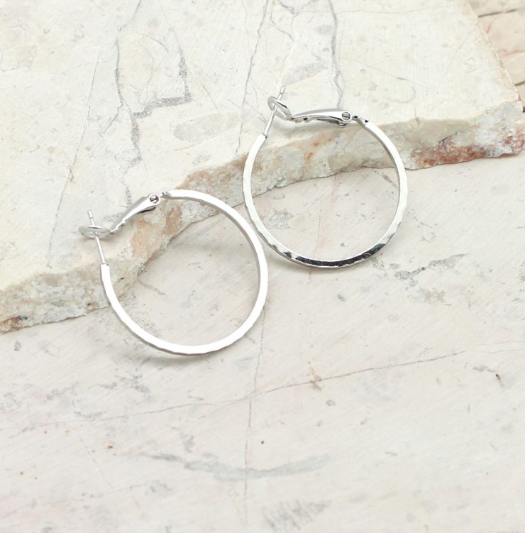 A photo of the Charming Chiseled Hoop Earrings product