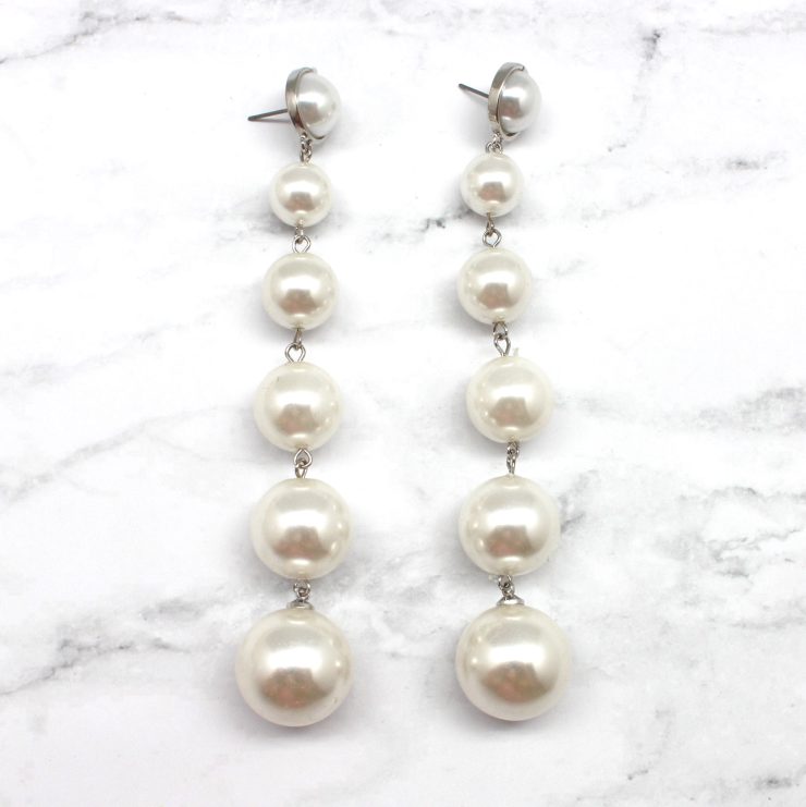 A photo of the Going Along Pearl Earrings product