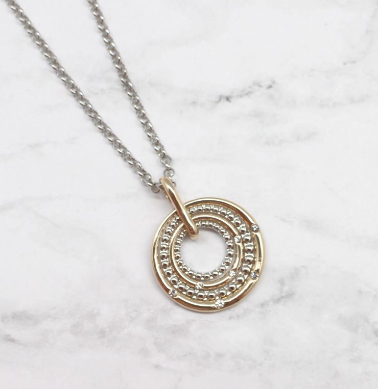 A photo of the Circling Into The Target Necklace product