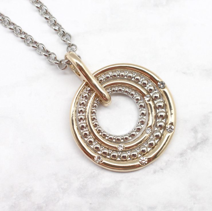 A photo of the Circling Into The Target Necklace product