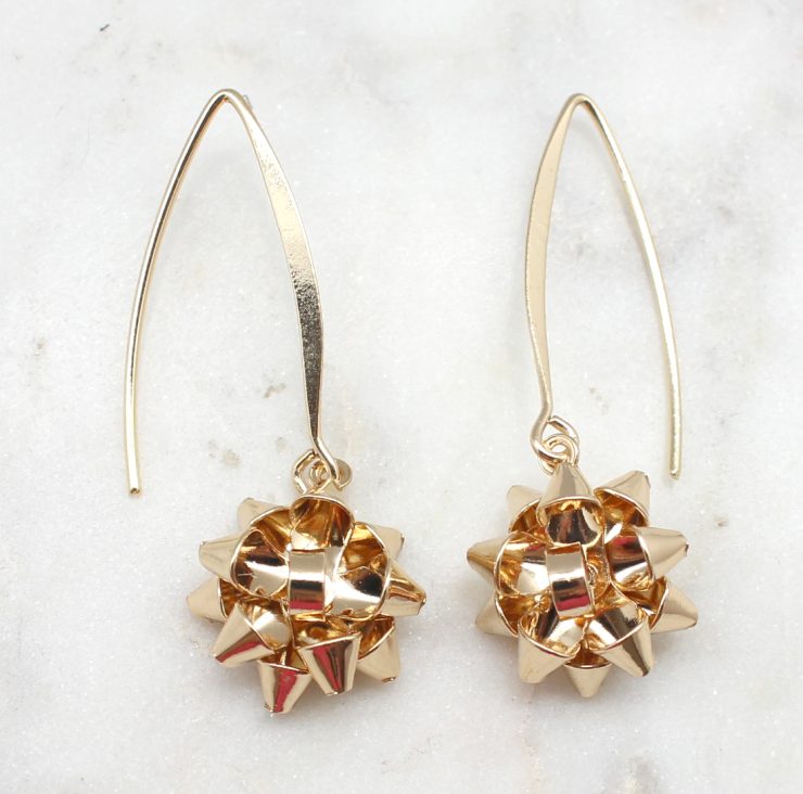 A photo of the Christmas Bow Dangle Earrings product