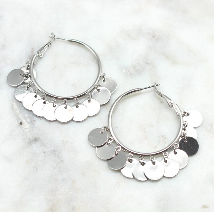 A photo of the Dangling Disc Hoop Earrings product