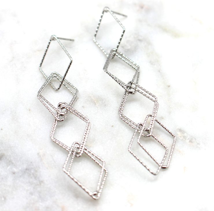 A photo of the Descending Dangle Earrings product
