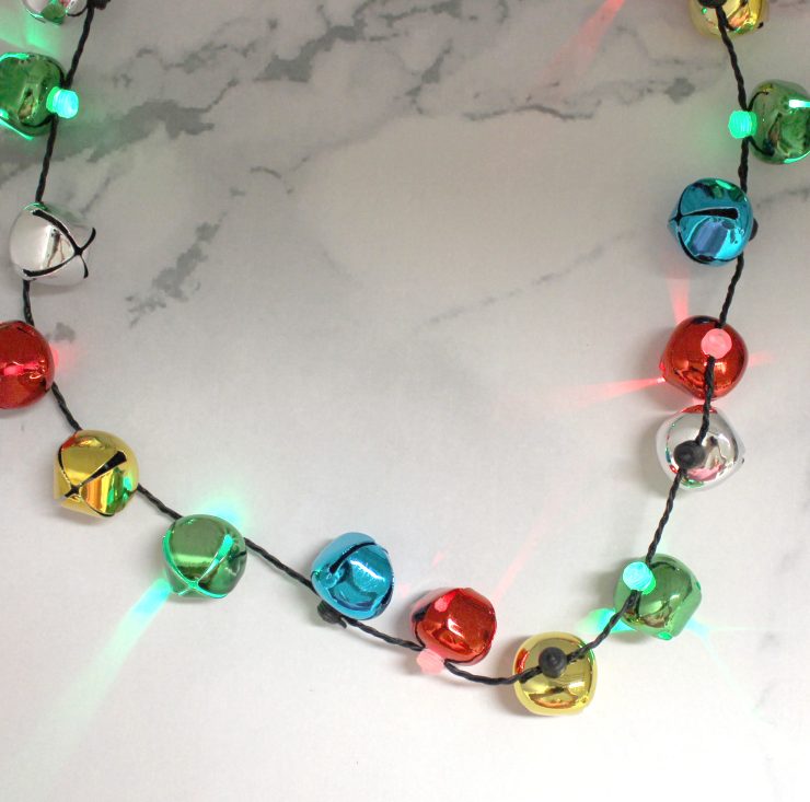 A photo of the Jingle Bell Light Up Necklace product