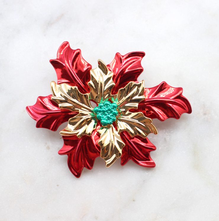 A photo of the Poinsettia Pin and Pendant product