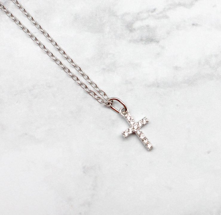 A photo of the Tiny Cross Necklace product