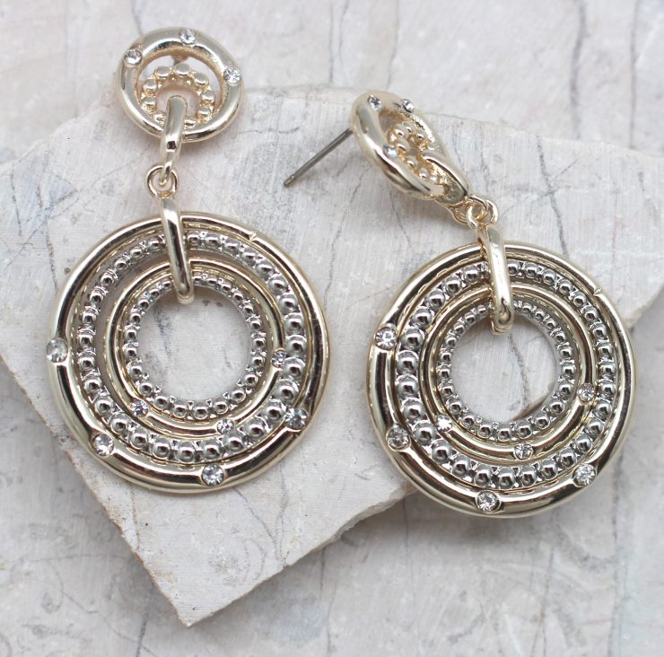 A photo of the Circling Into The Target Earrings product