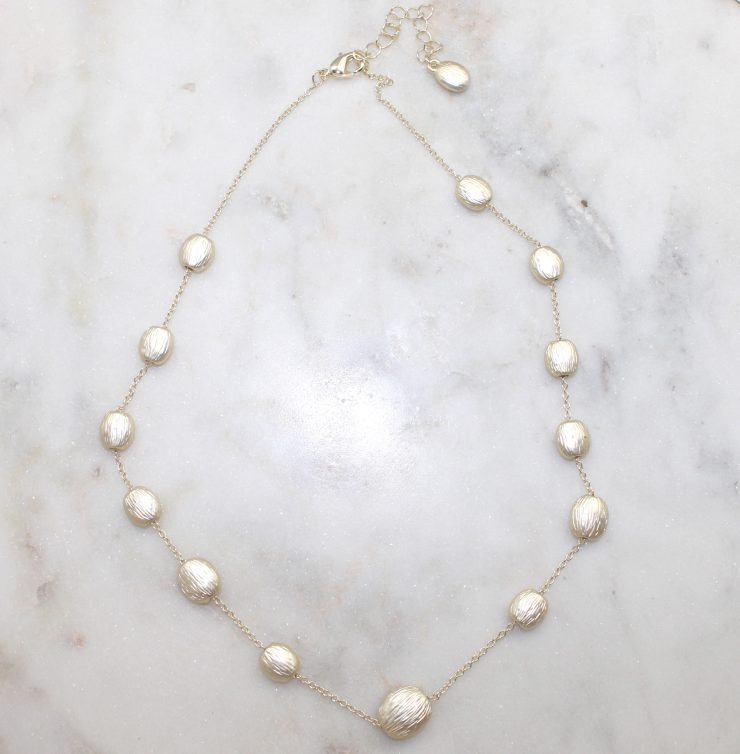 A photo of the Matte Gold Beaded Necklace product