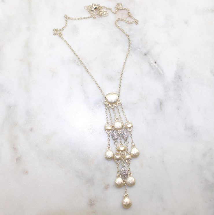 A photo of the Matte Gold Drops Necklace product