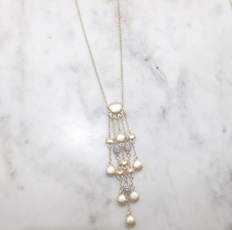 A photo of the Matte Gold Drops Necklace product