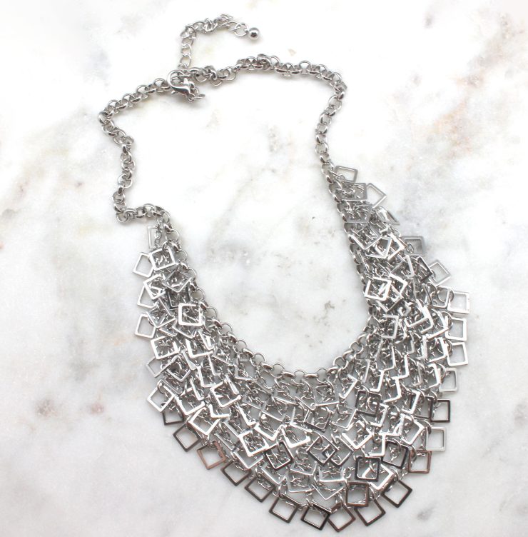 A photo of the Dangling Squares Necklace product
