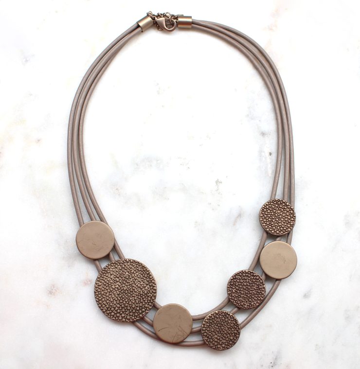 A photo of the Bronze Button Necklace product