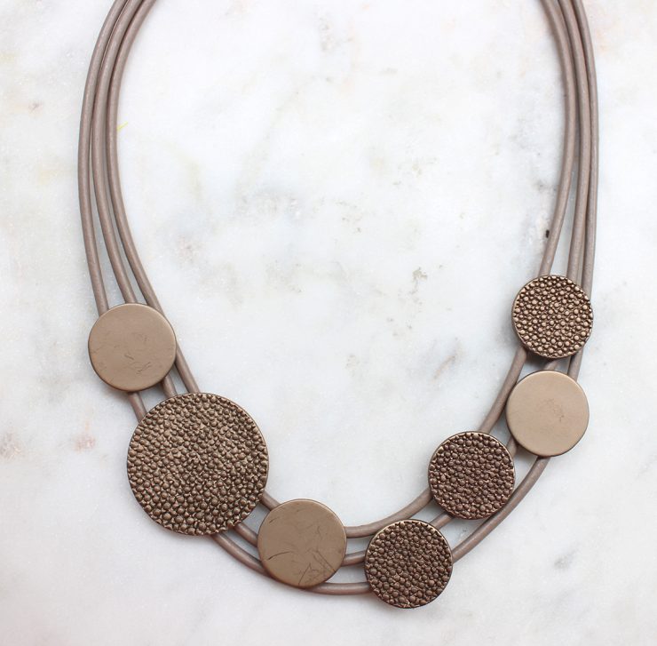 A photo of the Bronze Button Necklace product