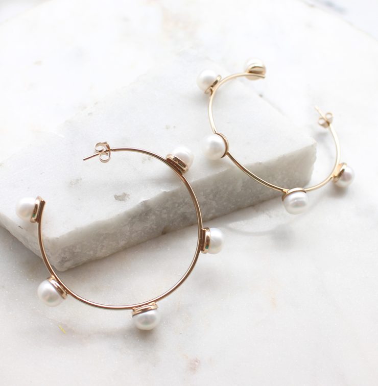 A photo of the Glimmer Hoop Earrings product