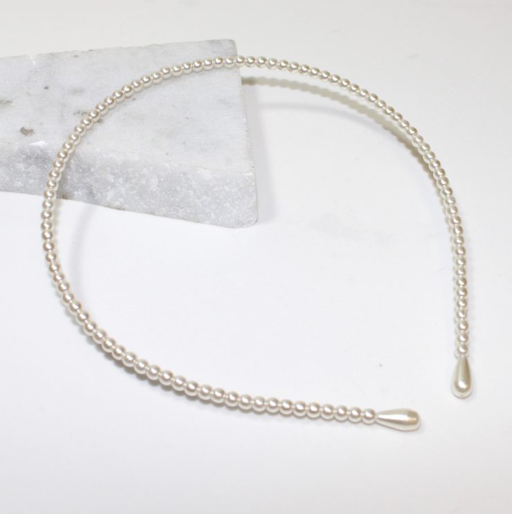 A photo of the Plain Pearl Headband product