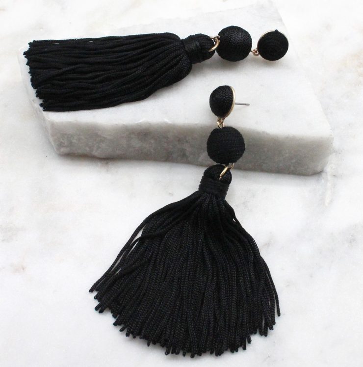 A photo of the Olé Tassel Earrings In Black product