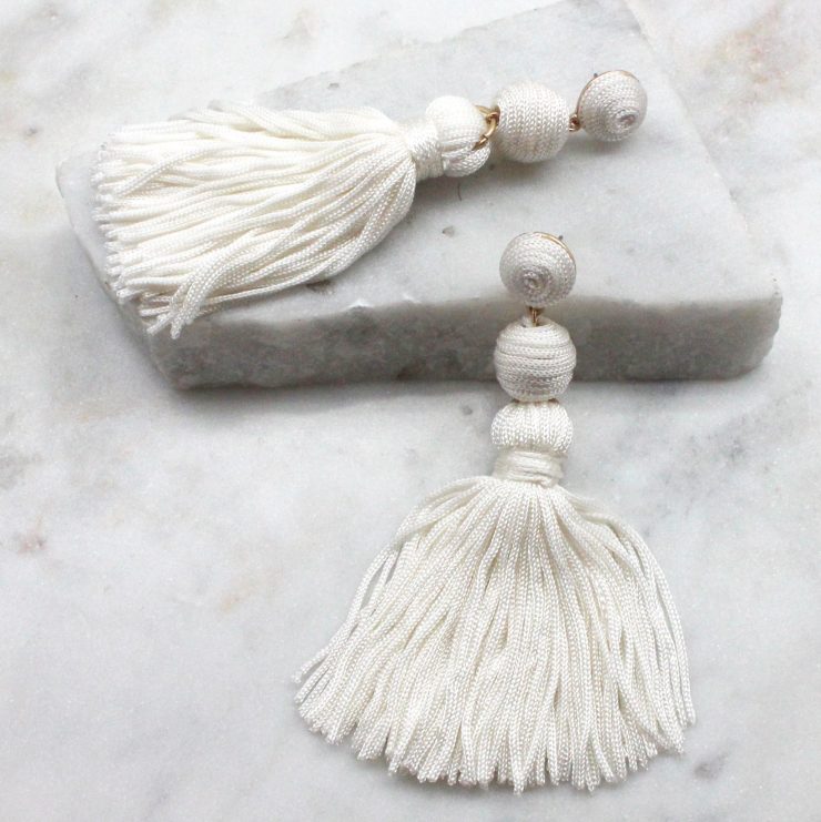 A photo of the Olé Tassel Earrings In White product