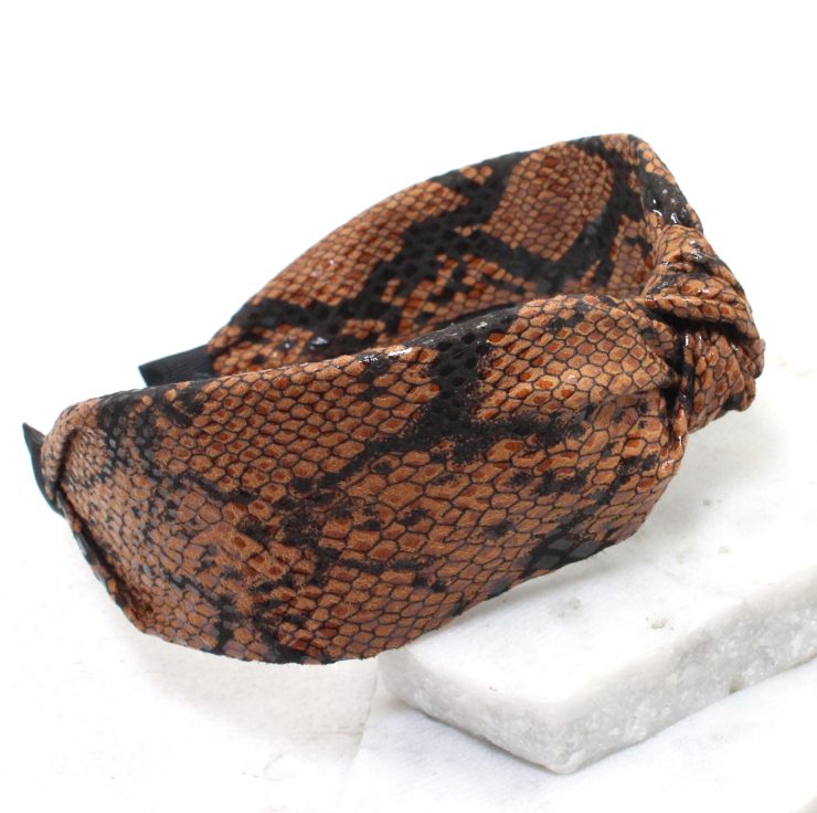 A photo of the Bitten Headband in Brown product