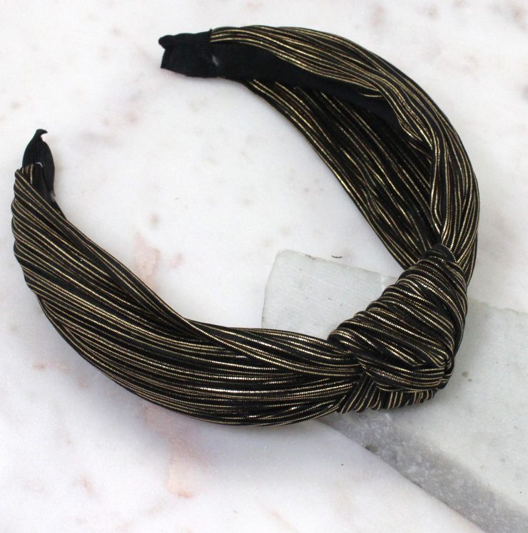 A photo of the Black and Gold Metallic Knot Headband product