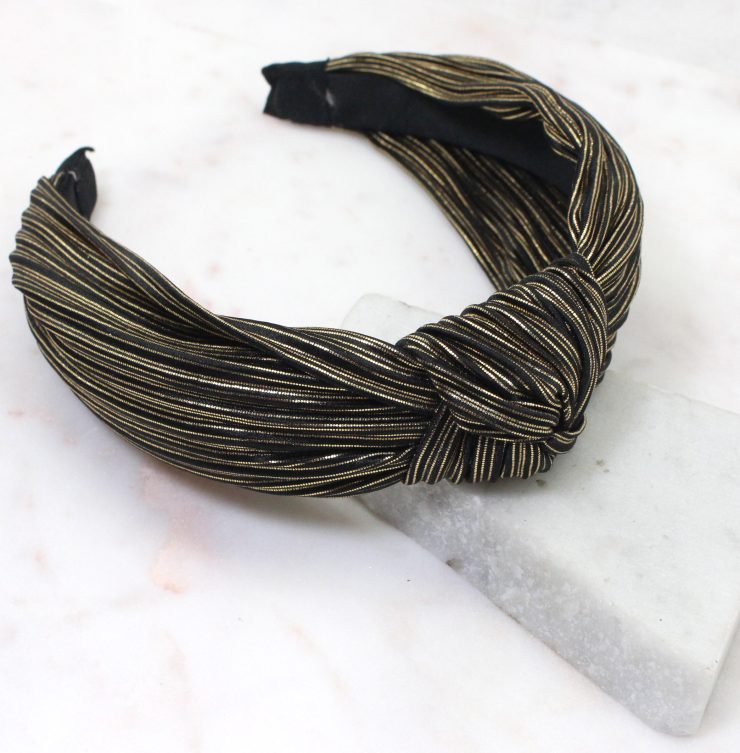 A photo of the Black and Gold Metallic Knot Headband product