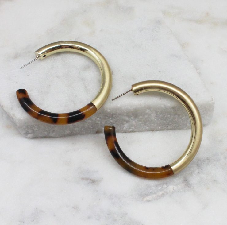 A photo of the Chloe Tortoise Shell & Gold Earrings product