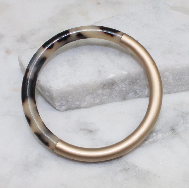 A photo of the Chloe Tortoise Shell Bangle In Rose Gold product