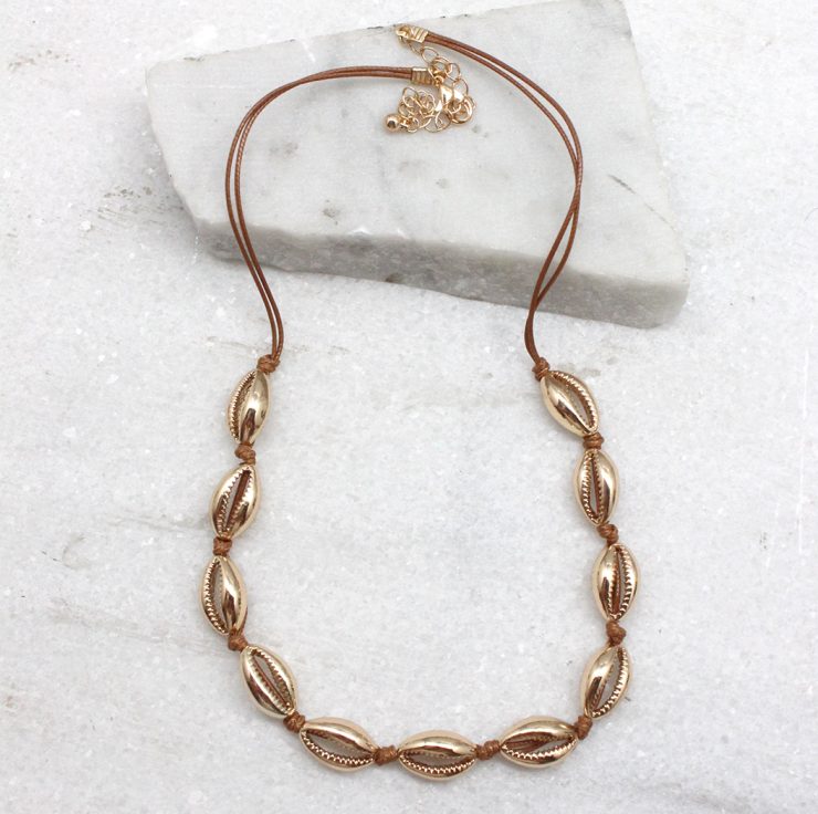 A photo of the Cowrie Knotted Necklace in Rose Gold & Turquoise product