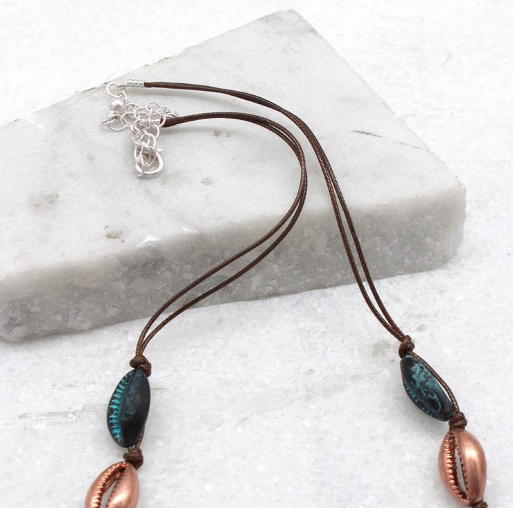 A photo of the Cowrie Knotted Necklace in Rose Gold & Turquoise product