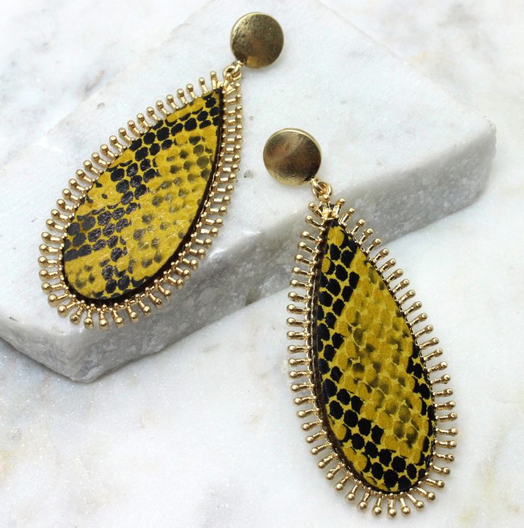 A photo of the Wild Bound Snake Print Earrings product