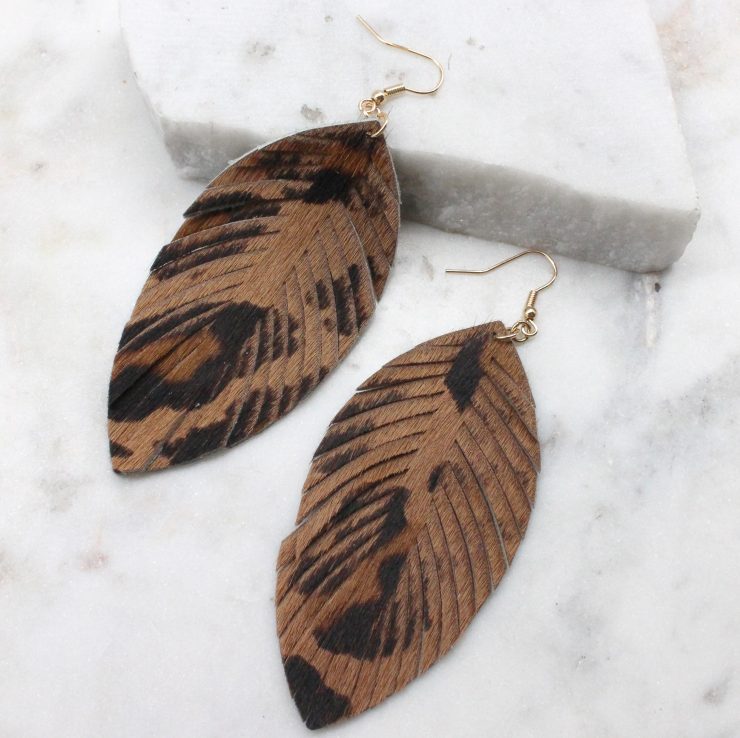 A photo of the Leopard Feather Earrings product