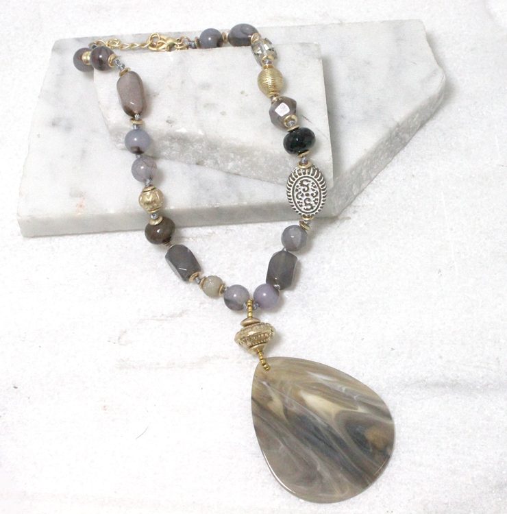 A photo of the Marbled Petal Necklace in Grey product