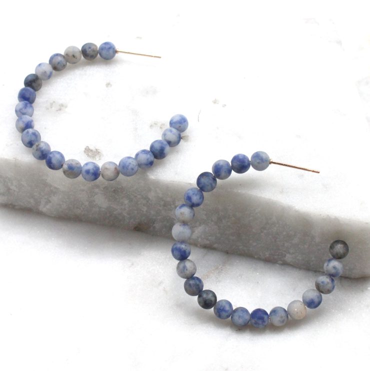 A photo of the Matte Beaded Hoops product