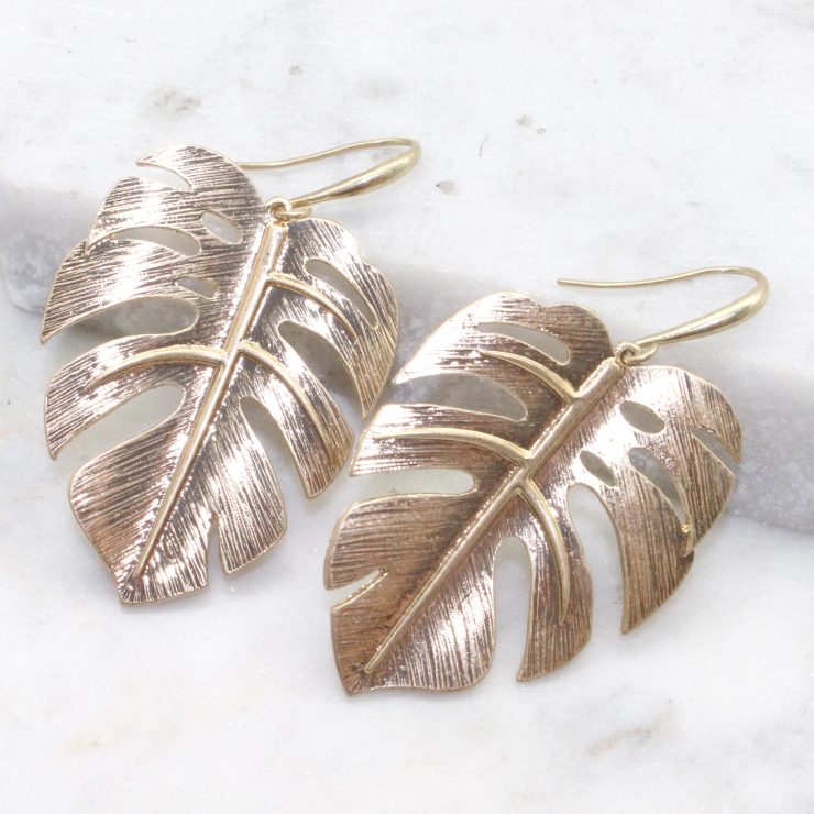 A photo of the Monstera Leaf Earrings product
