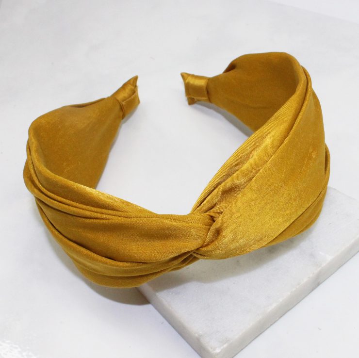 A photo of the Mustard Twist Headband product