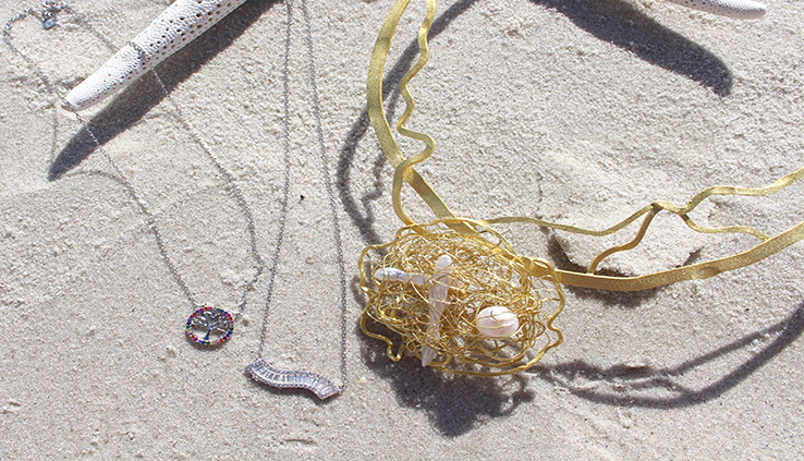 Photo of necklaces in the sand