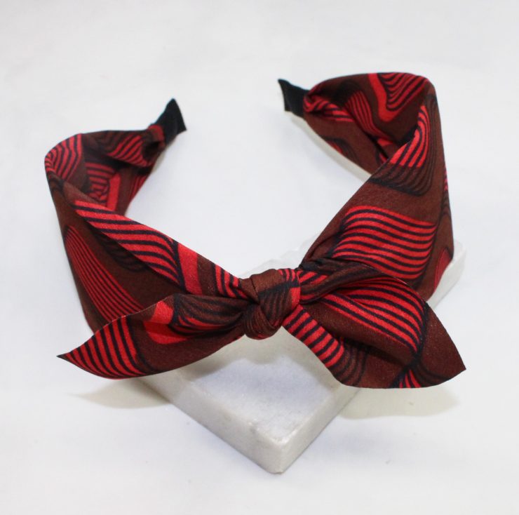 A photo of the Red & Brown Swirl Headband product