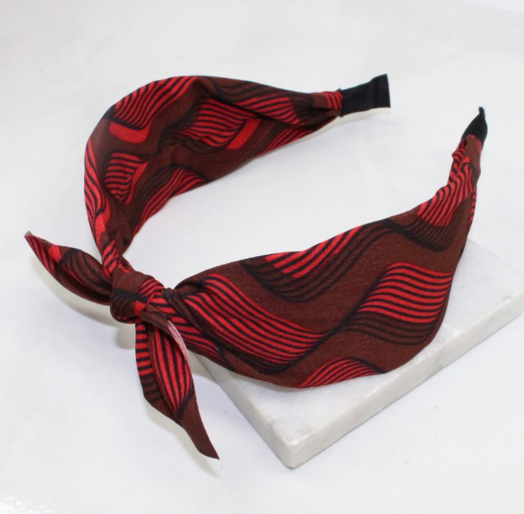 A photo of the Red & Brown Swirl Headband product