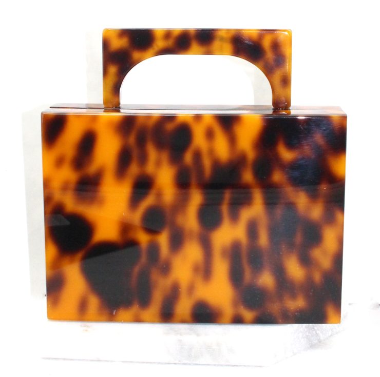 A photo of the Scarlett Tortoiseshell Clutch product