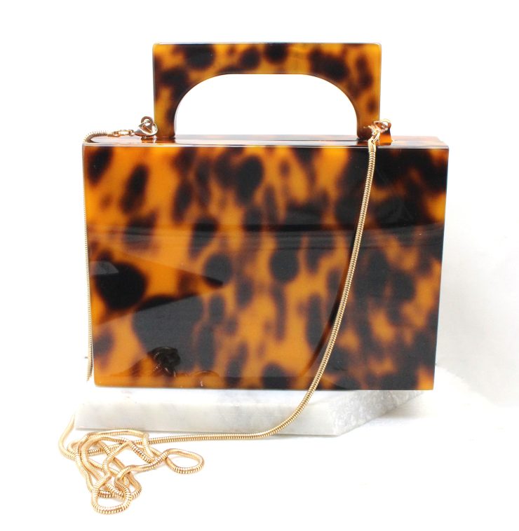 A photo of the Scarlett Tortoiseshell Clutch product