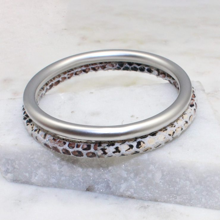A photo of the Slithering Through Bangle Set In White product