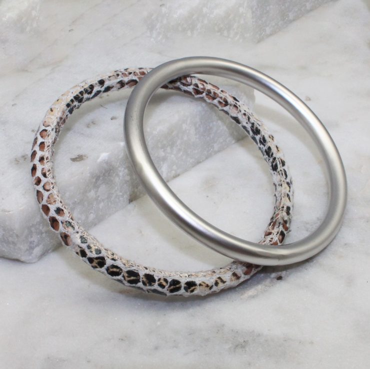 A photo of the Slithering Through Bangle Set In White product